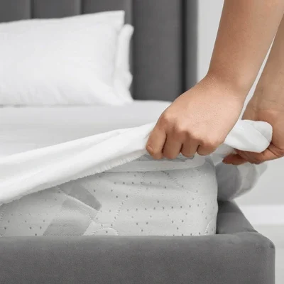 woman-putting-cover-on-mattress-600nw-2393232095